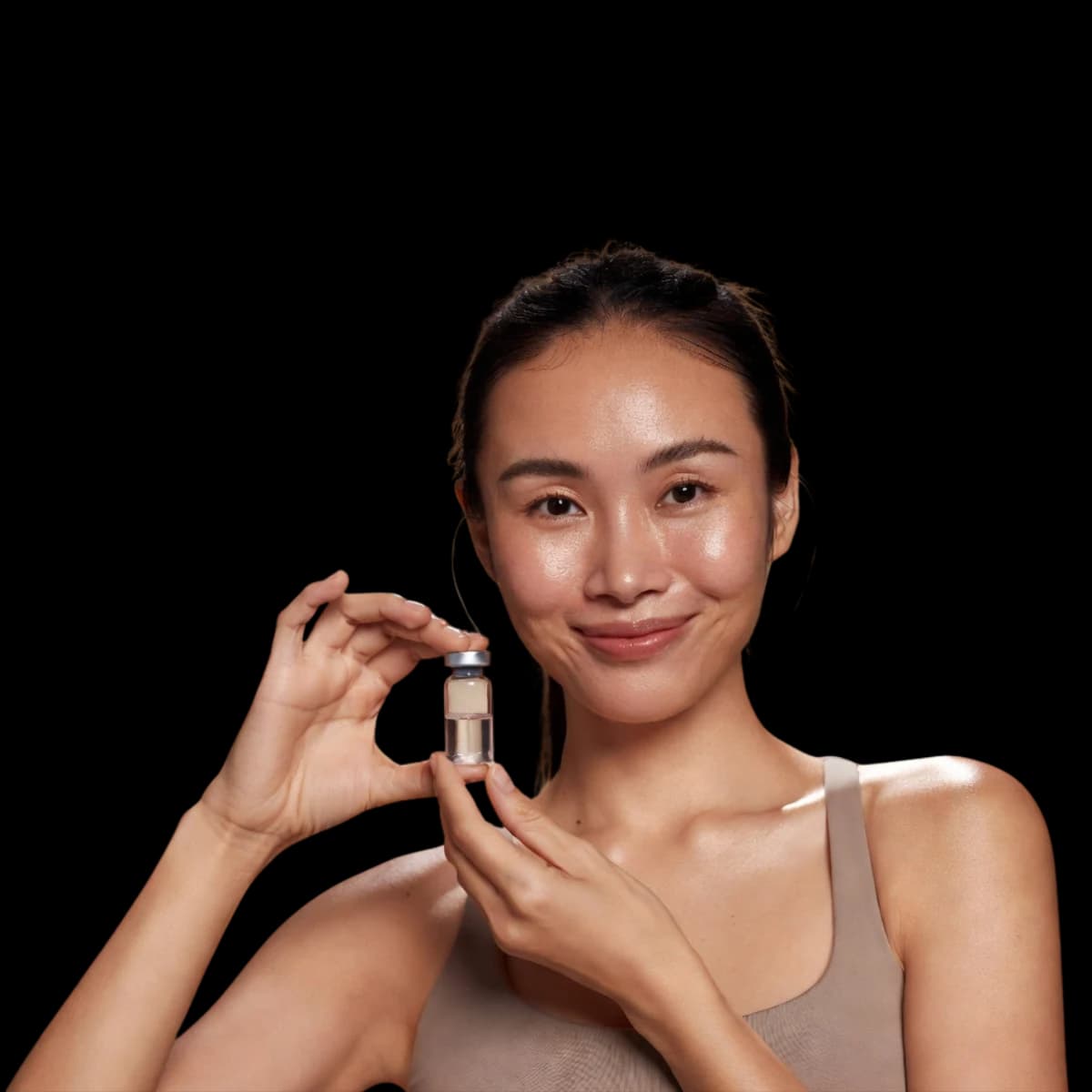 Woman holding peptide vial